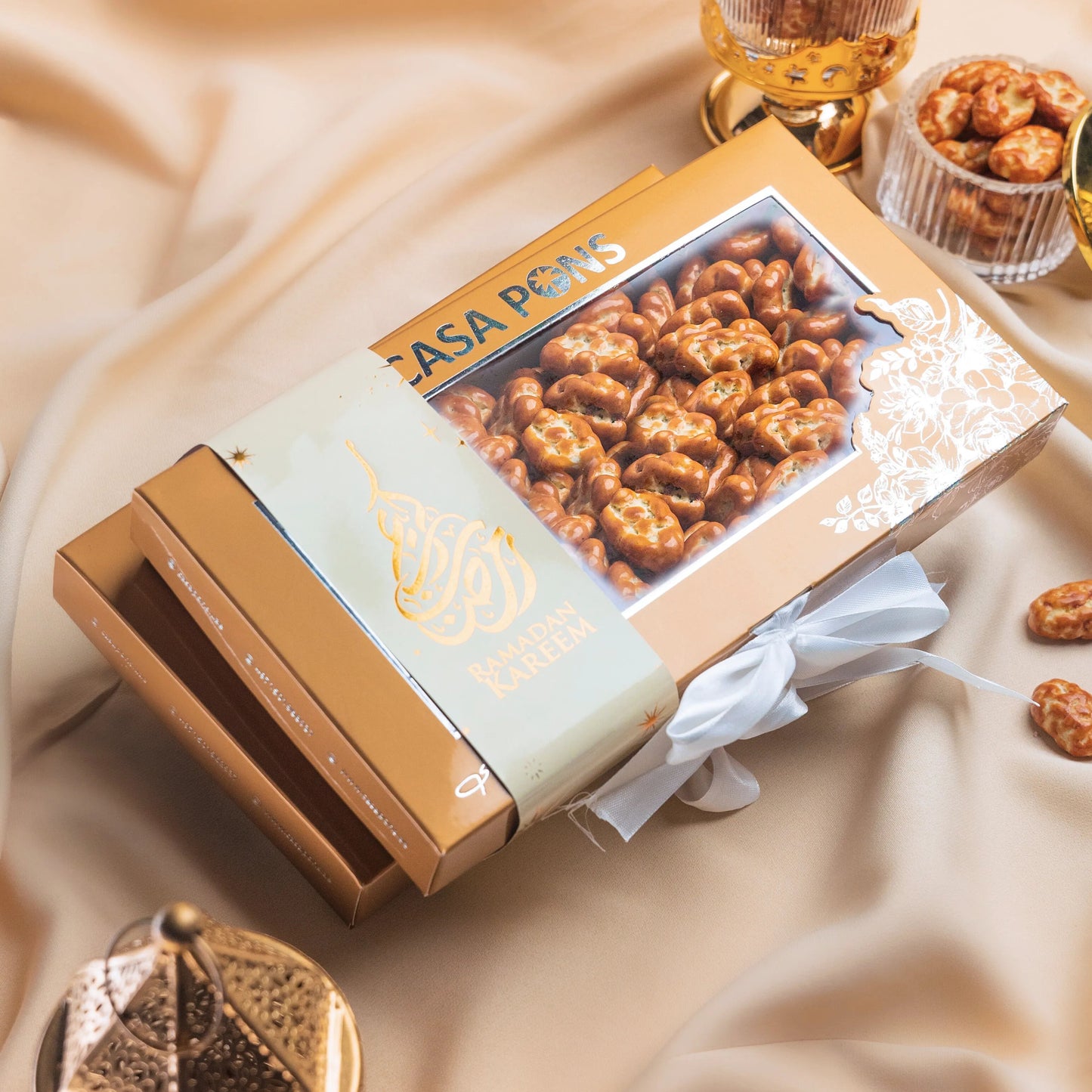 Casa Pops popcorn box on a beige fabric background with decorative elements.