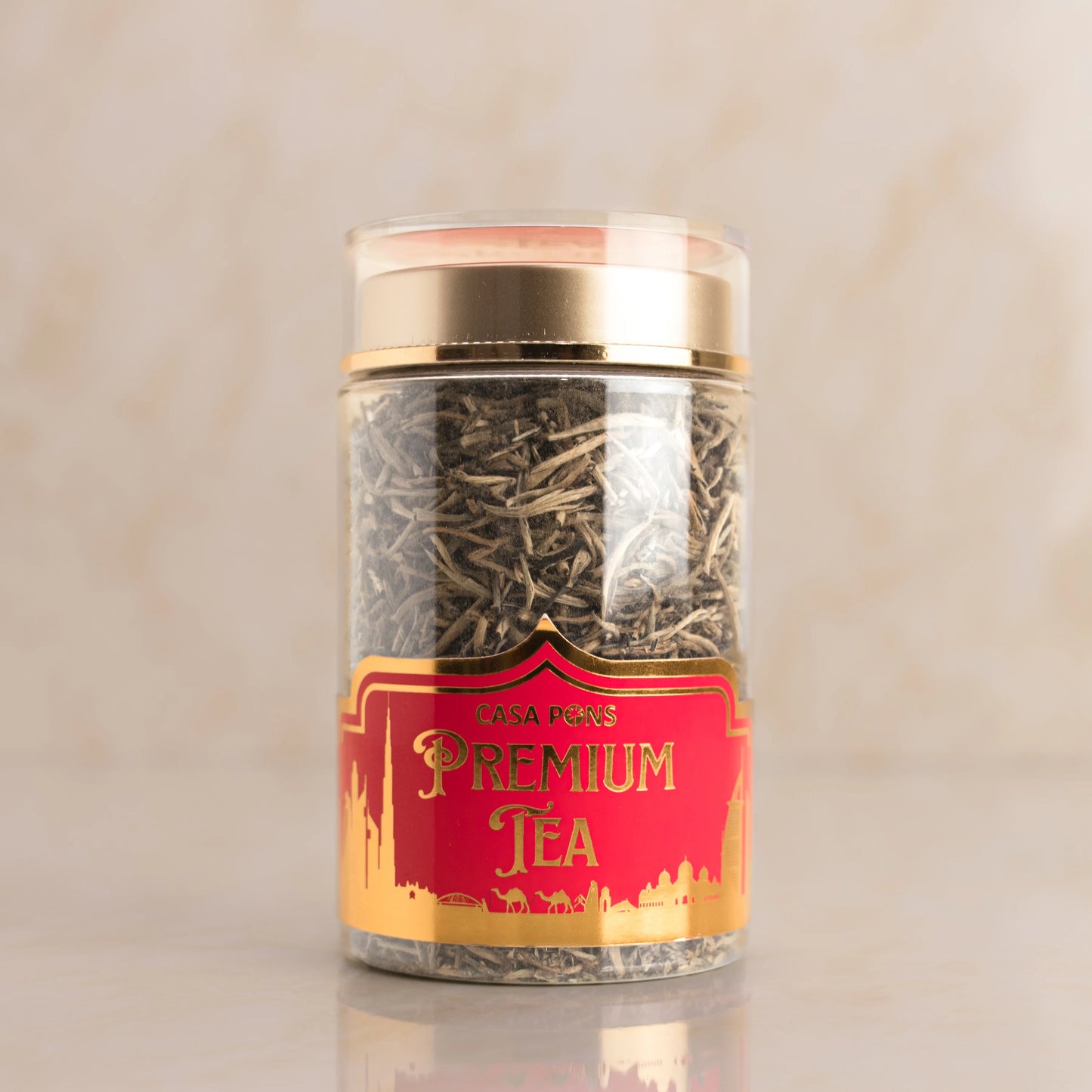 Jar of premium tea with a red label on a beige background