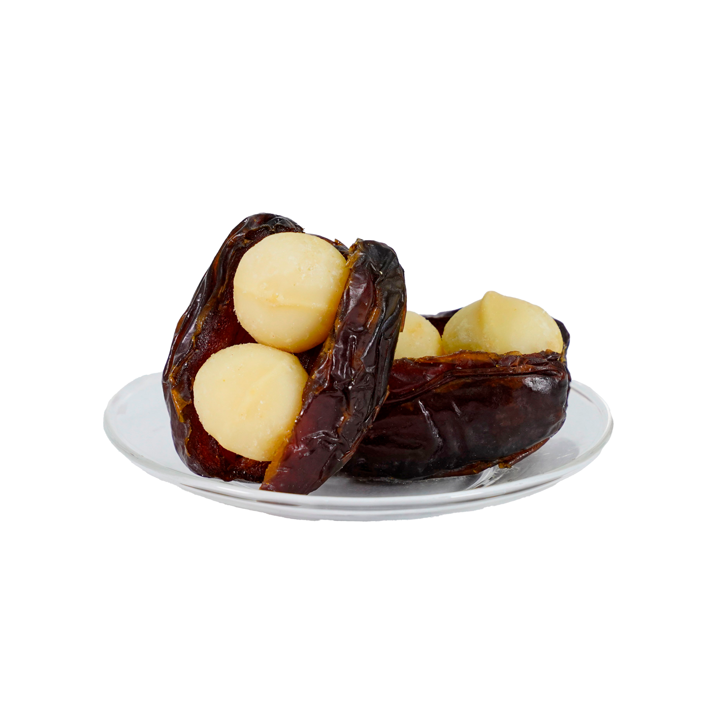 A plate with several dates each containing a macadamia nut, set against a white background.