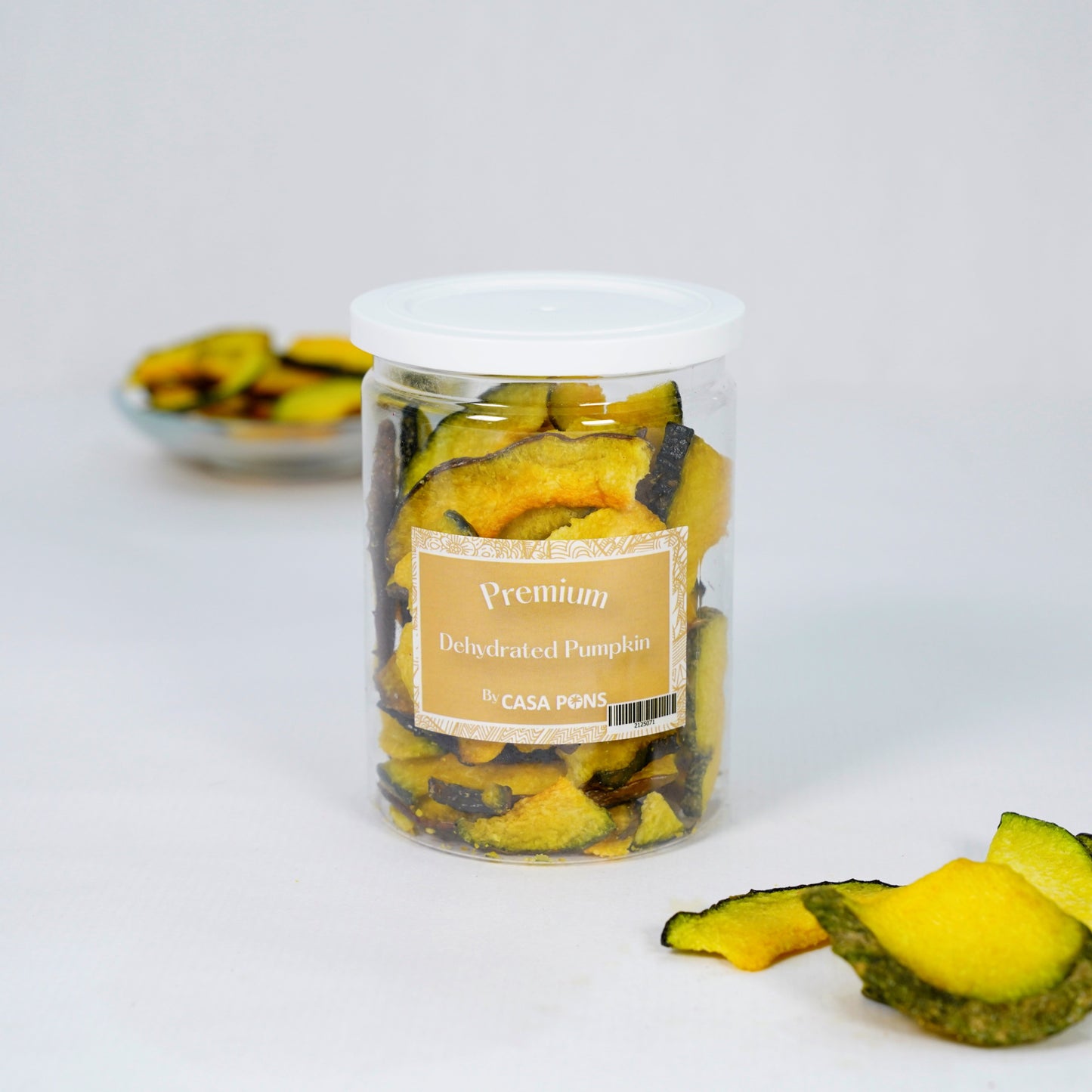 Jar of dehydrated pumpkin slices with a label on a white background