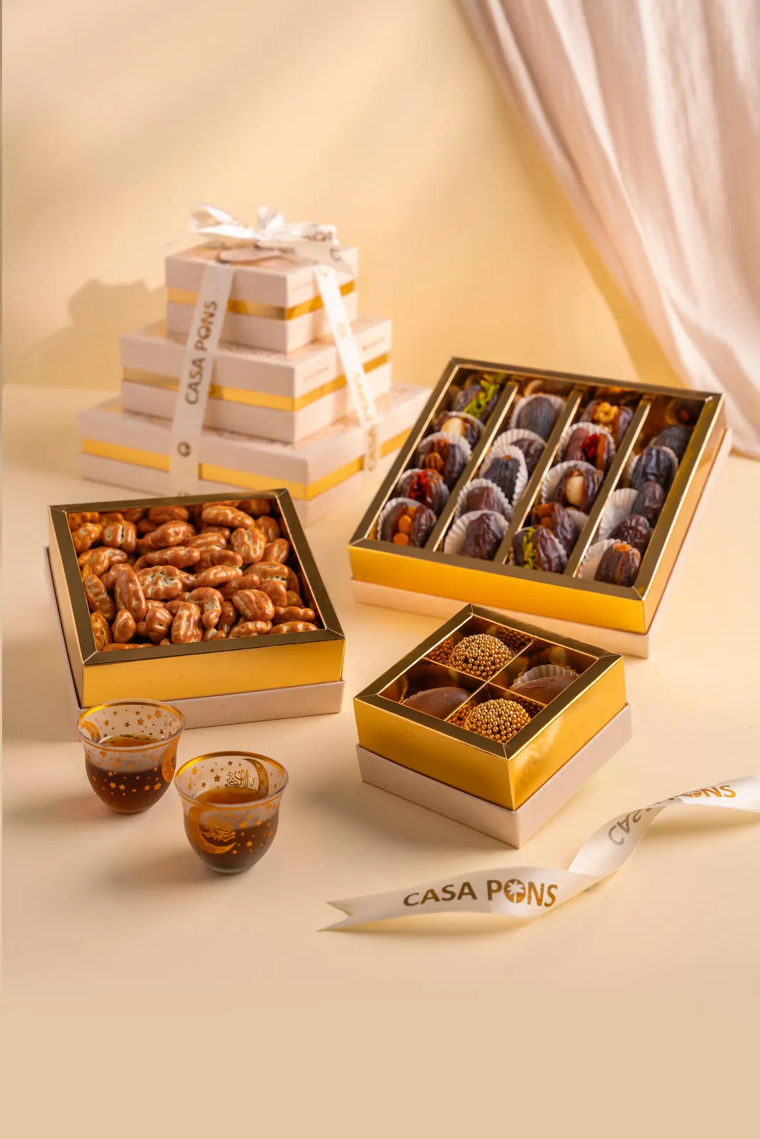 Casa Pigna chocolate boxes with various chocolates on a beige surface.