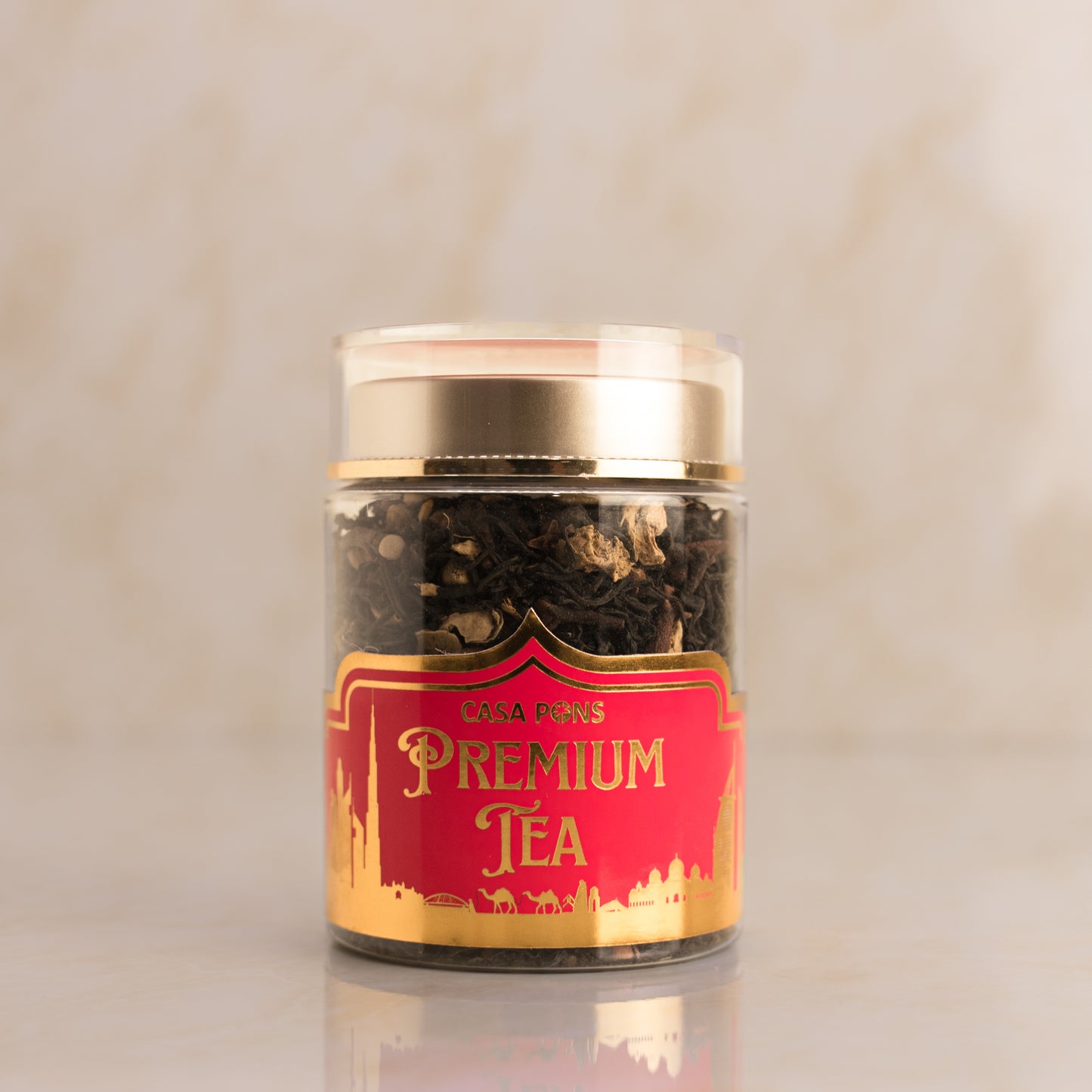 Café Picos Premium Tea canister with red and gold label on a beige background