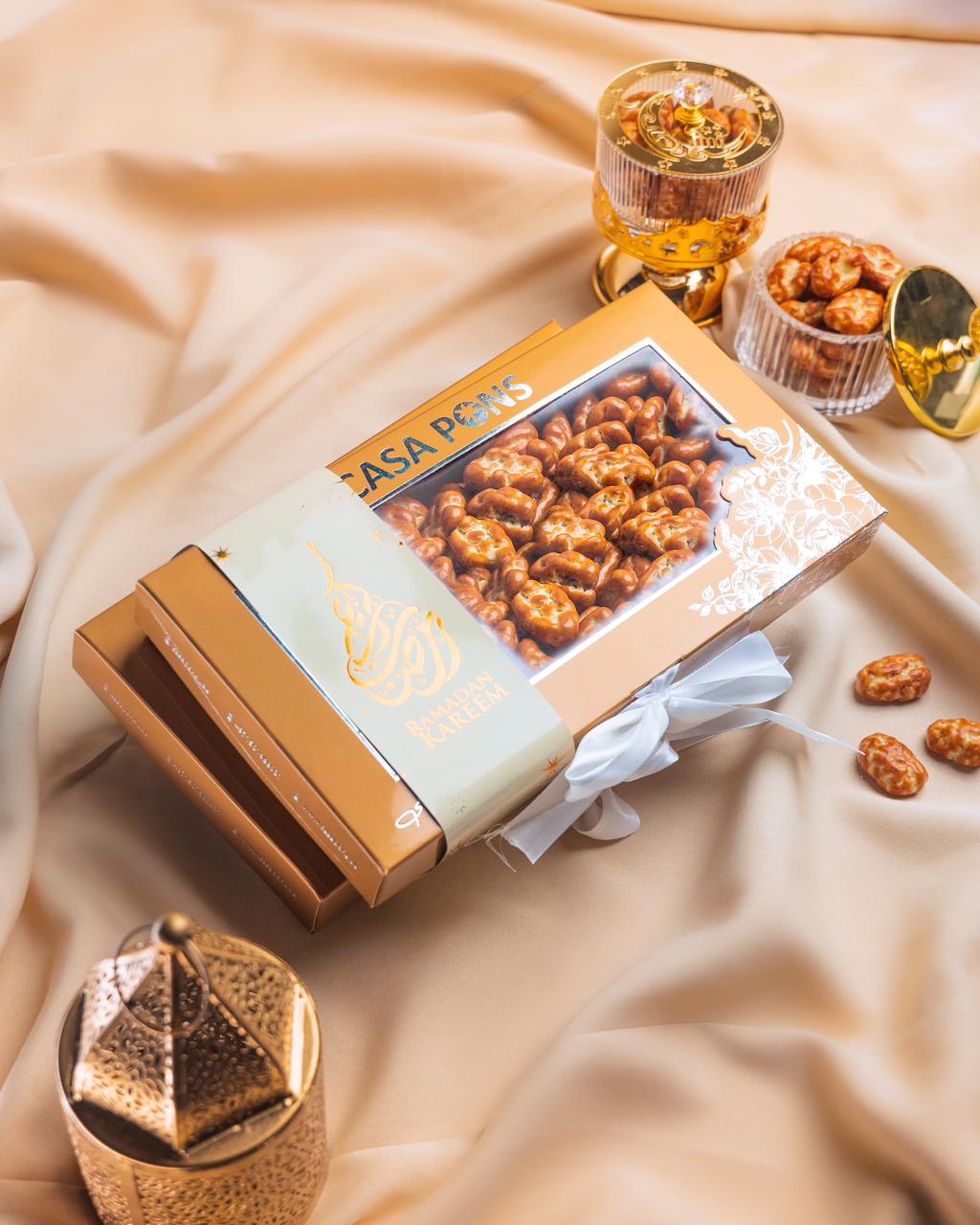 Box of Casa Perez pretzels on a beige fabric background with decorative items.