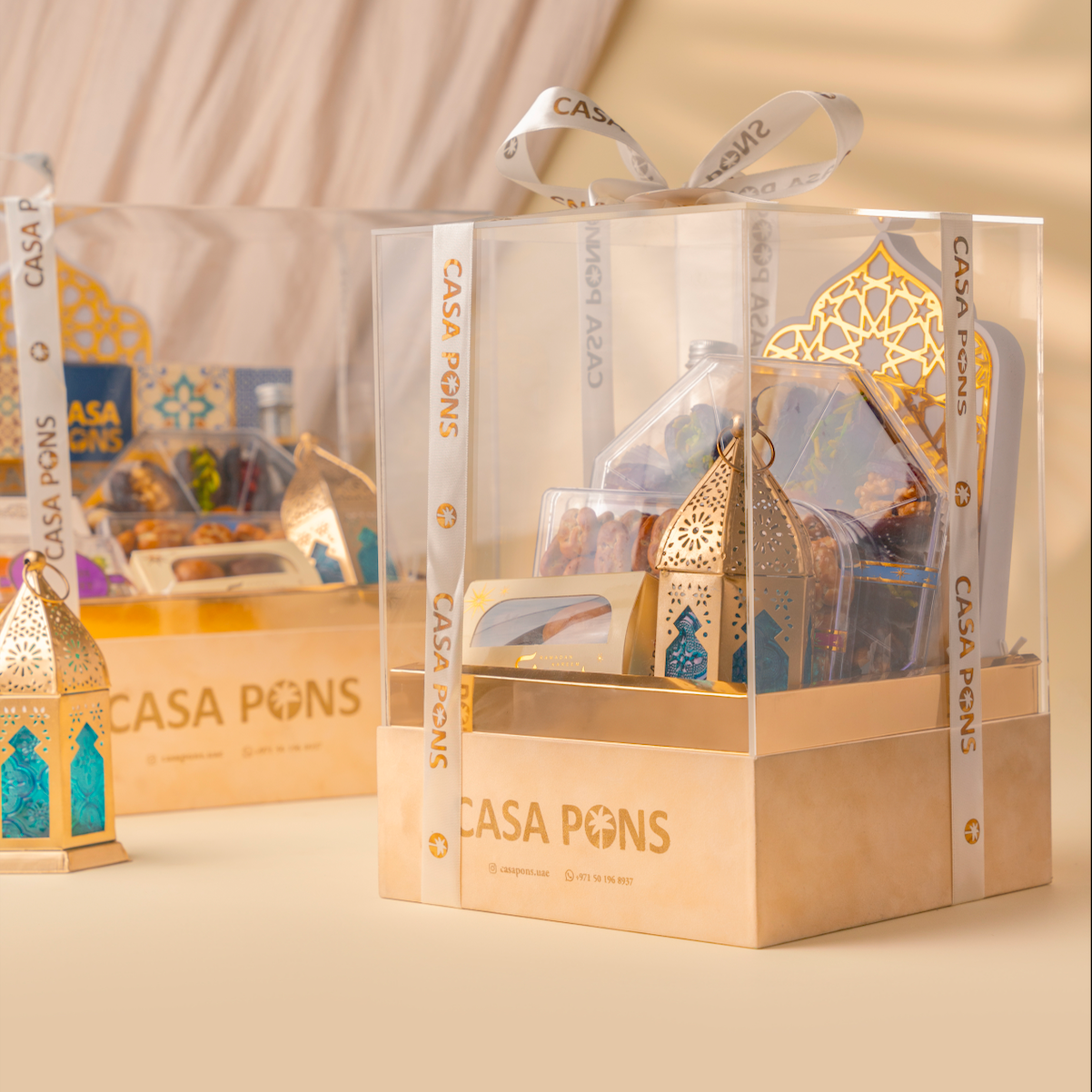 Decorative lanterns in clear packaging with 'CASA PONS' branding on a beige background