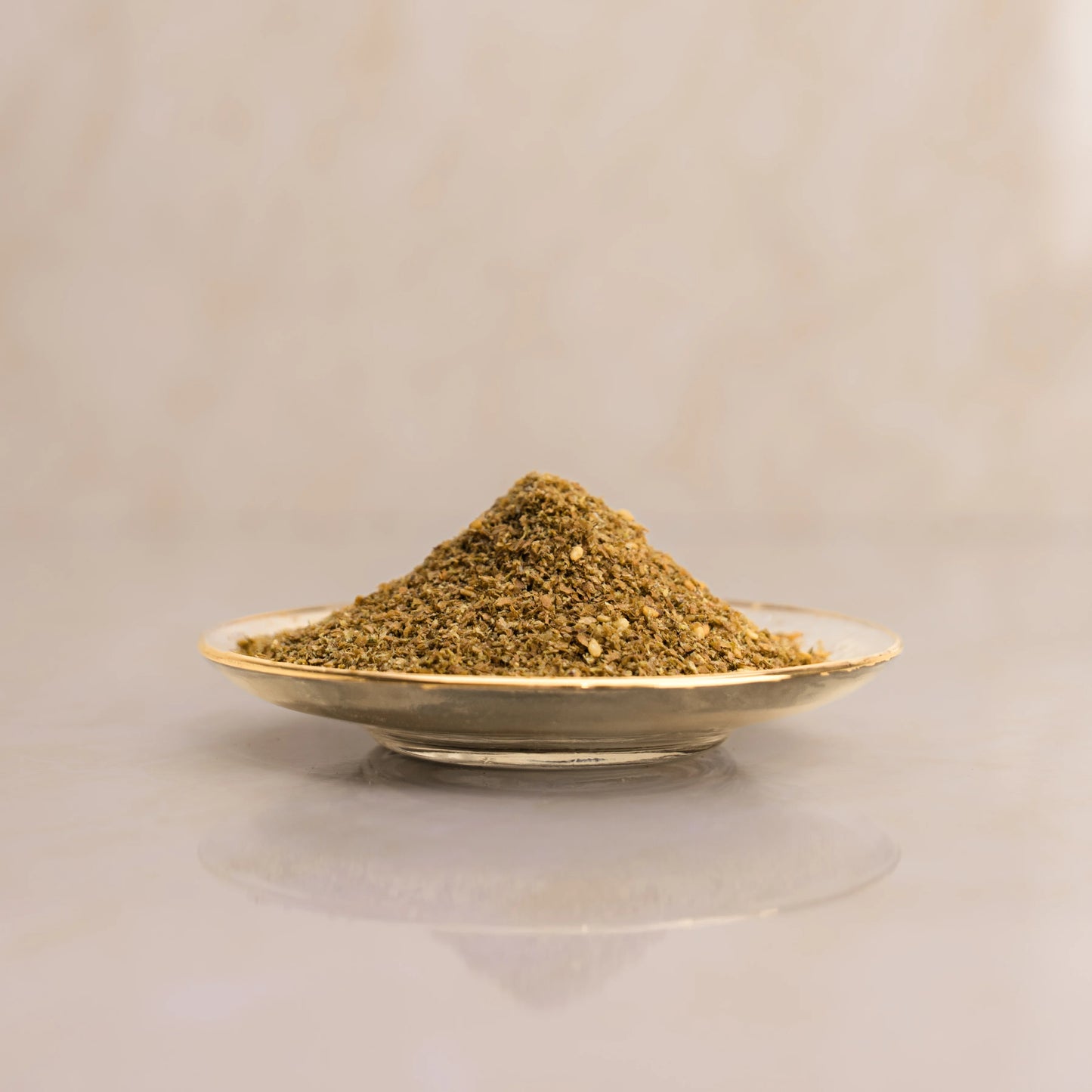 Herbal powder on a small plate with a beige background
