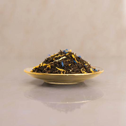 Tea leaves on a gold plate with a beige background