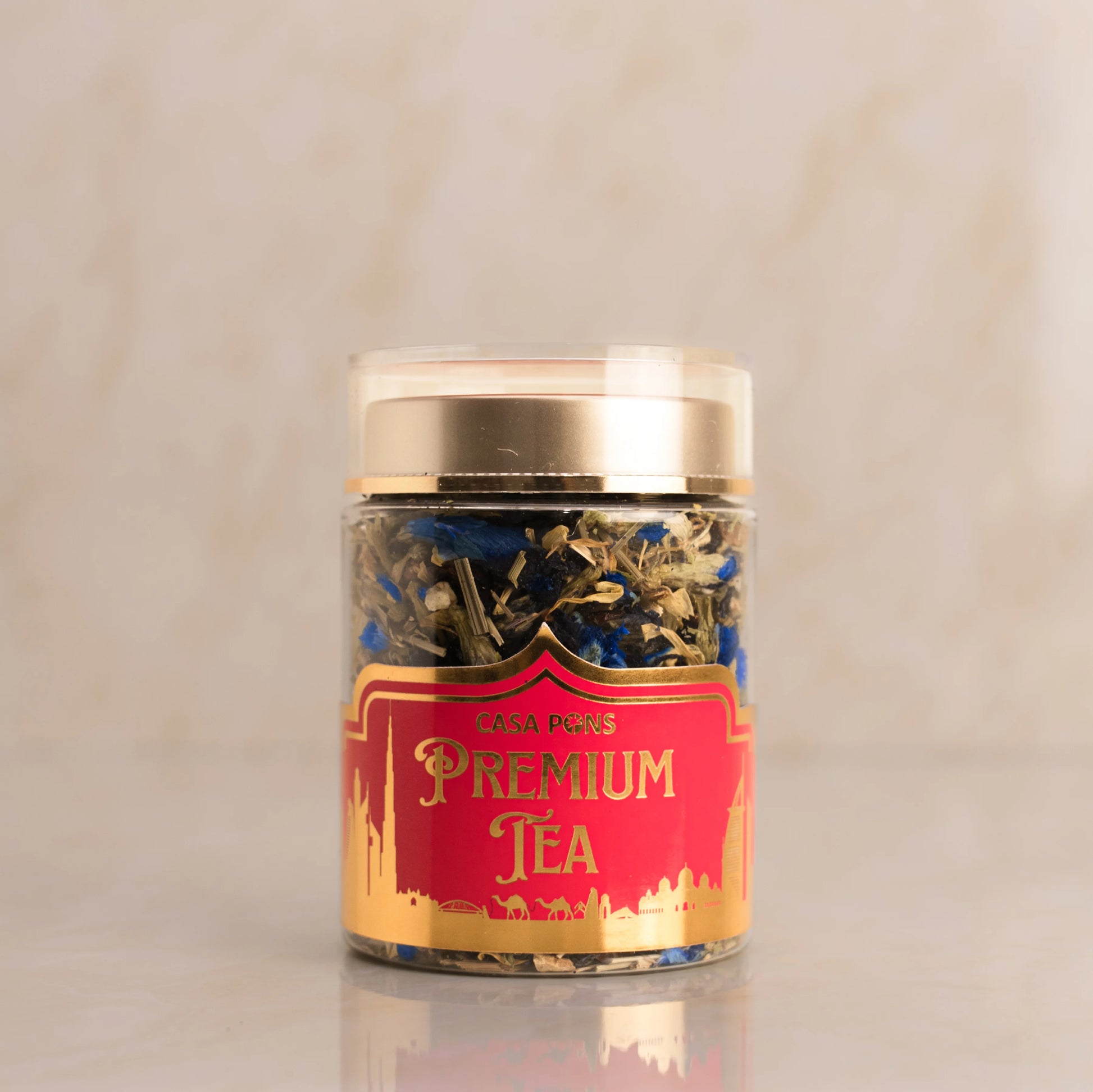 Jar of premium tea with a red label on a beige background