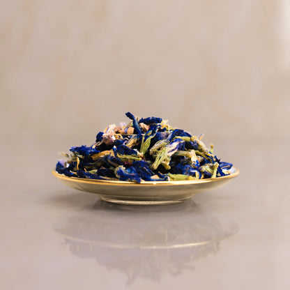 Dried blue and white flowers on a beige plate against a beige background