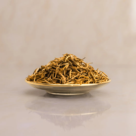 Dried herbs on a white plate with a beige background