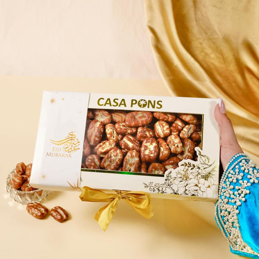 Casa Pons box of dried fruits with a decorative bow on a beige background