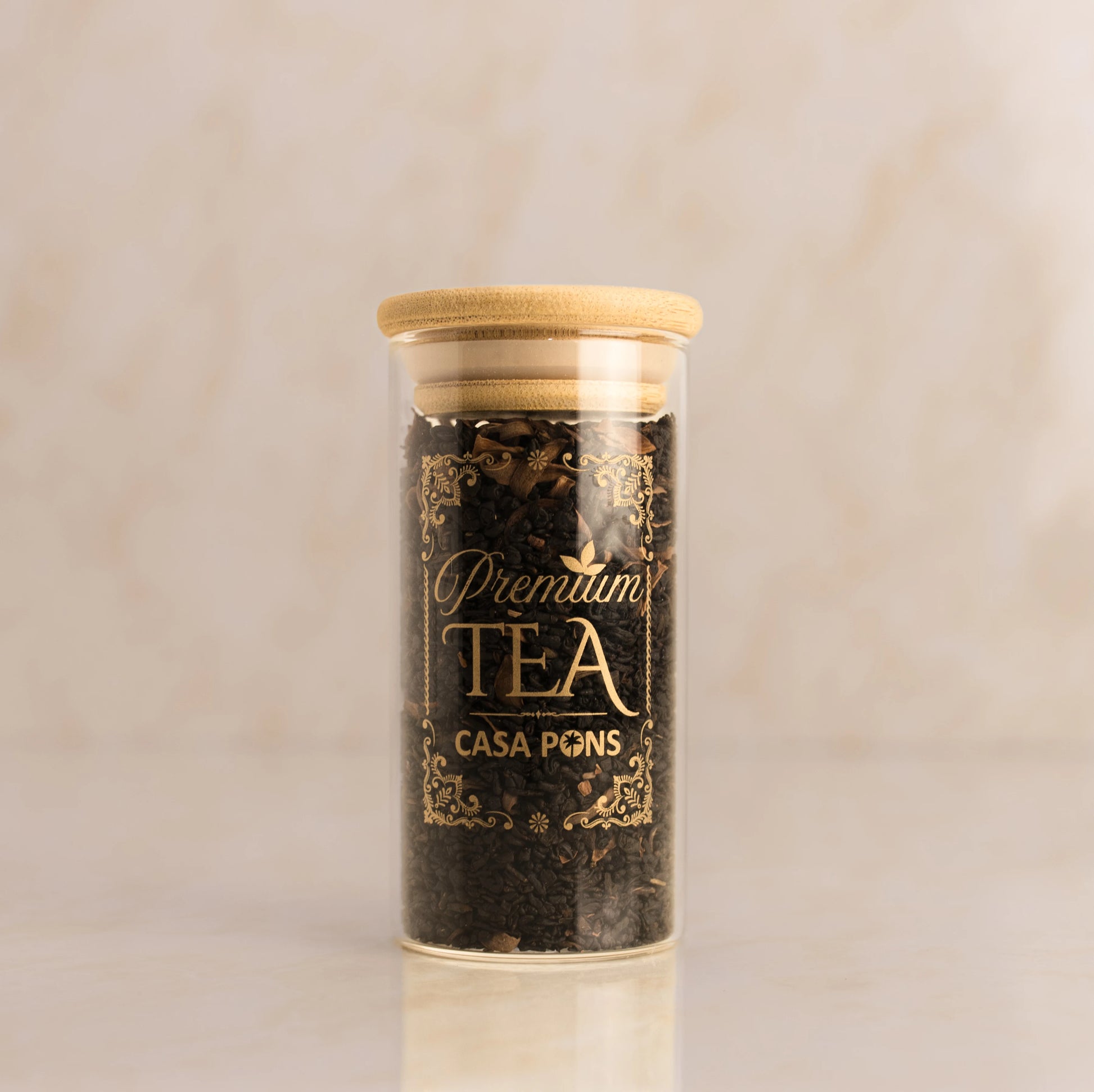 Jar of Casa PQNS tea with a wooden lid on a beige background