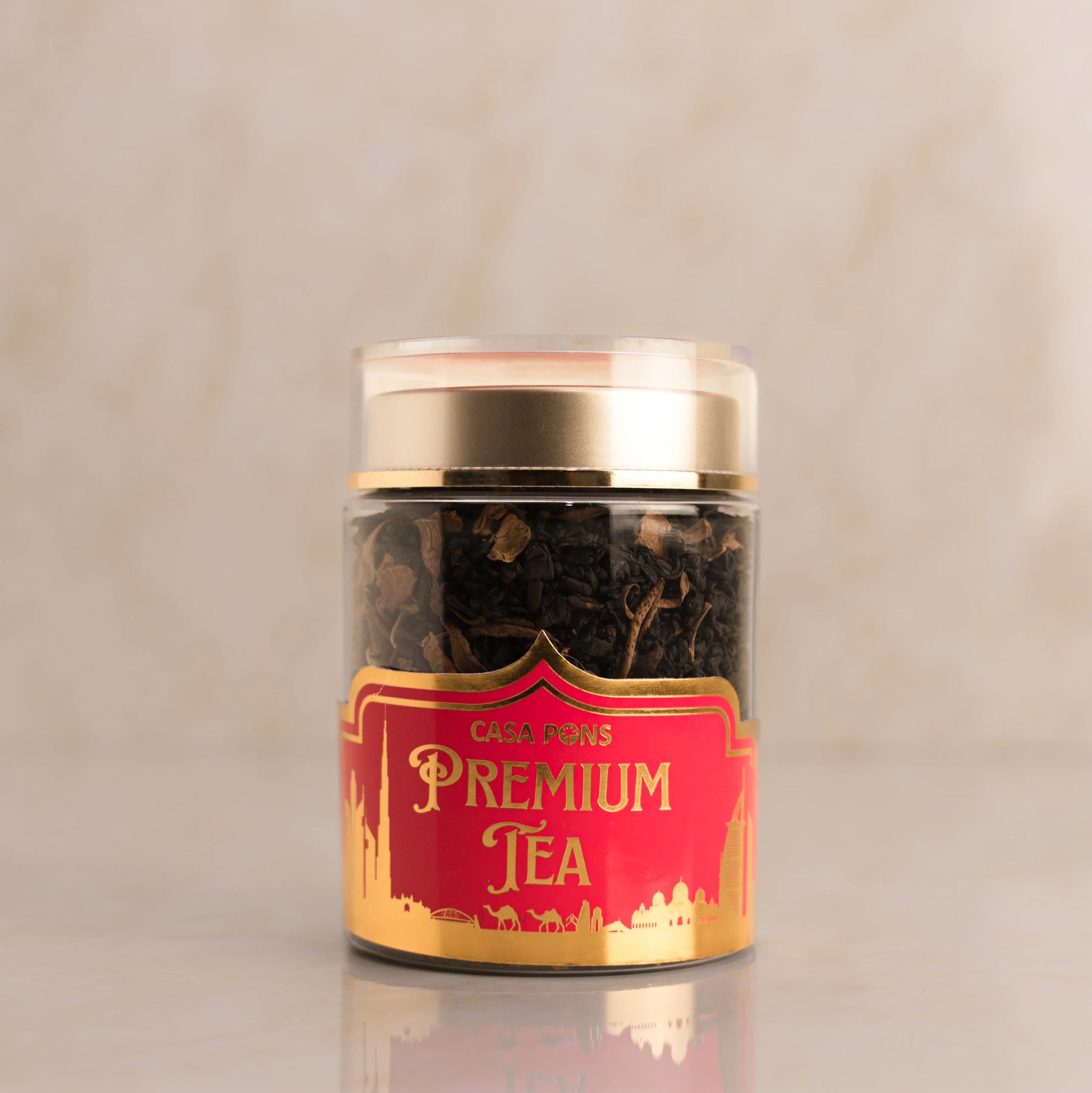 Jar of premium tea with a red label on a beige background