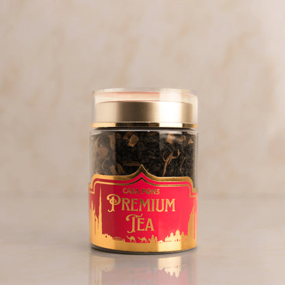 Jar of premium tea with a red label on a beige background