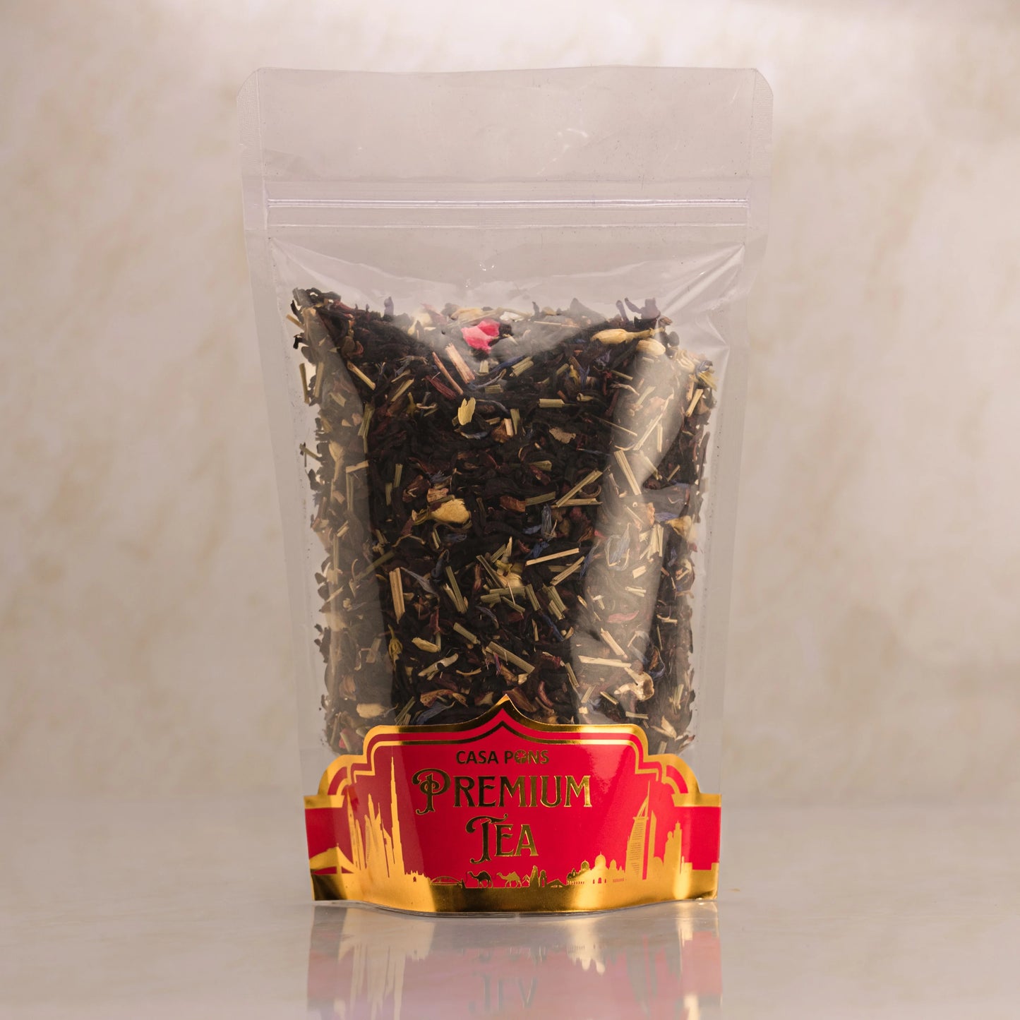 Clear package of premium tea with a red label on a light gray background