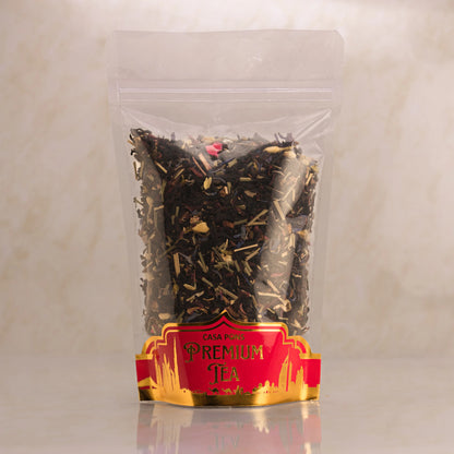Clear package of premium tea with a red label on a light gray background