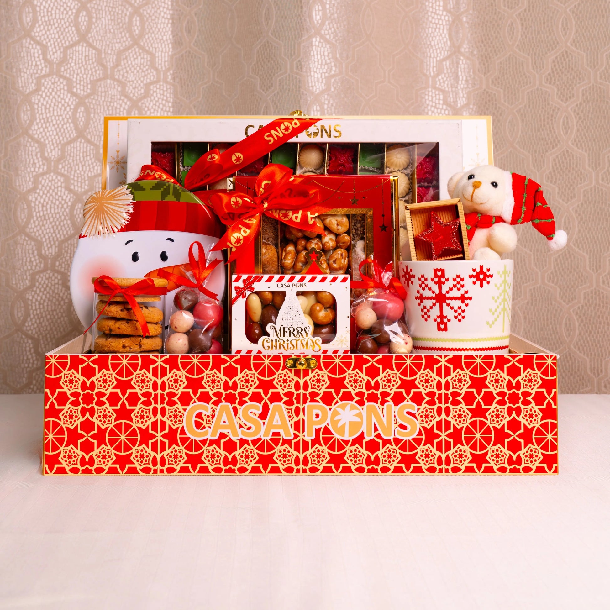 Casa Pons Christmas gift set with various items on a decorative background