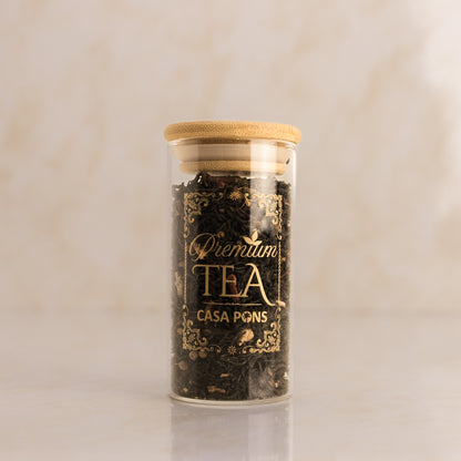 Jar of Casa Pons tea with a wooden lid on a beige background