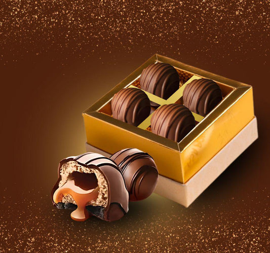 Delicate chocolate truffles in a decorative box on a brown background