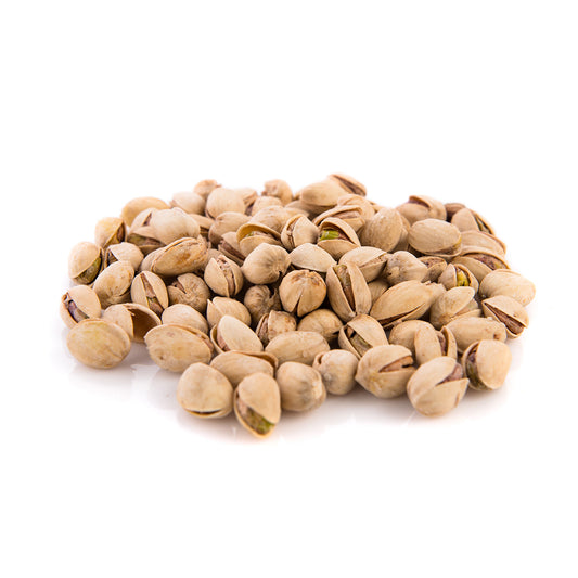 A pile of salted pistachio nuts isolated on a white background