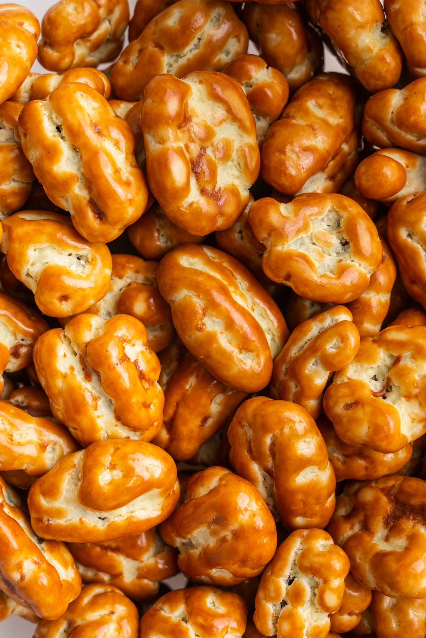 Close-up of a pile of brown, textured pecans