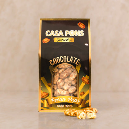 Packaging of Casa Pons Chocolate Pecan Pops on a beige background