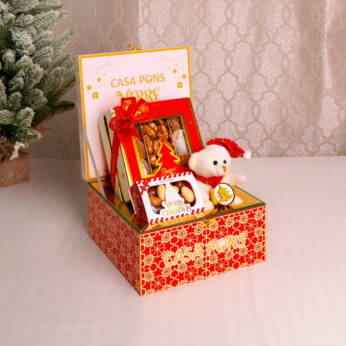 Decorative gift box with a teddy bear and photo frame on a neutral background
