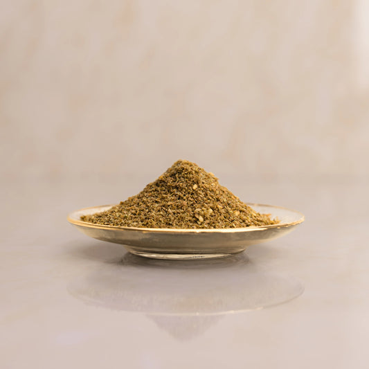 Herbal powder on a small plate with a beige background