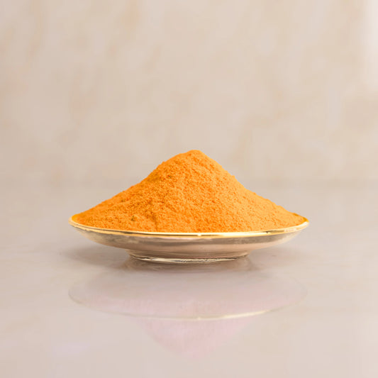 Pile of orange powder on a beige background