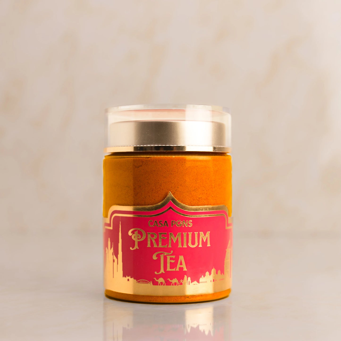 Casa Pons Premium Tea canister with gold lid on a beige background