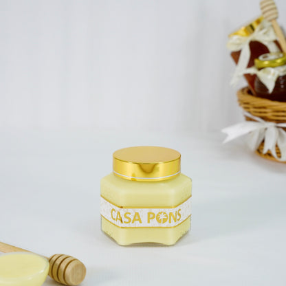 Jar of Casa Pons honey with a gold lid on a white background