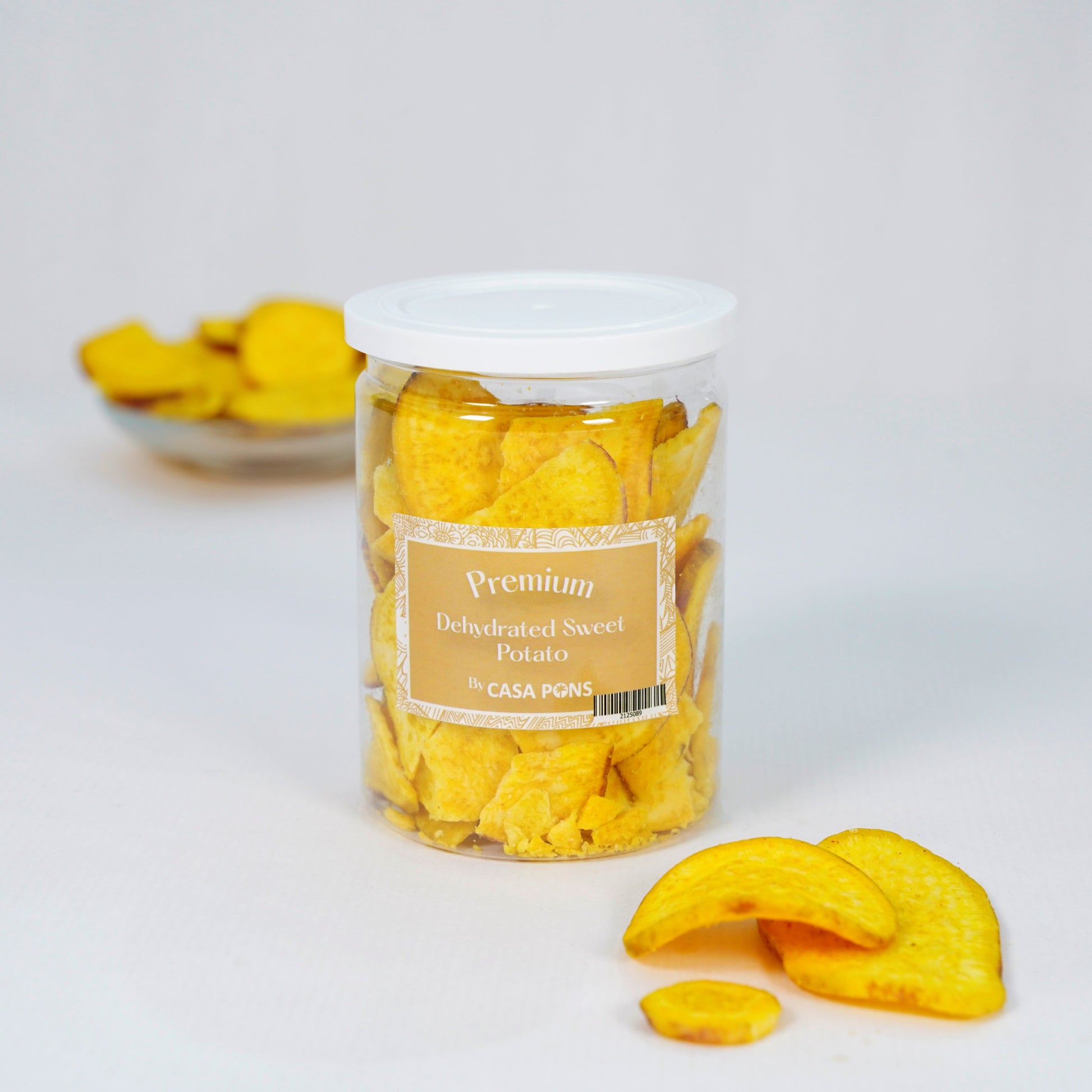 Jar of dehydrated sweet potato chips with a label on a white background