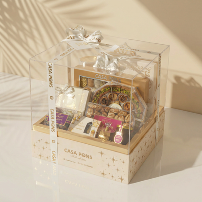 Gift box with various items inside, branded 'Casa Pons', on a light surface.