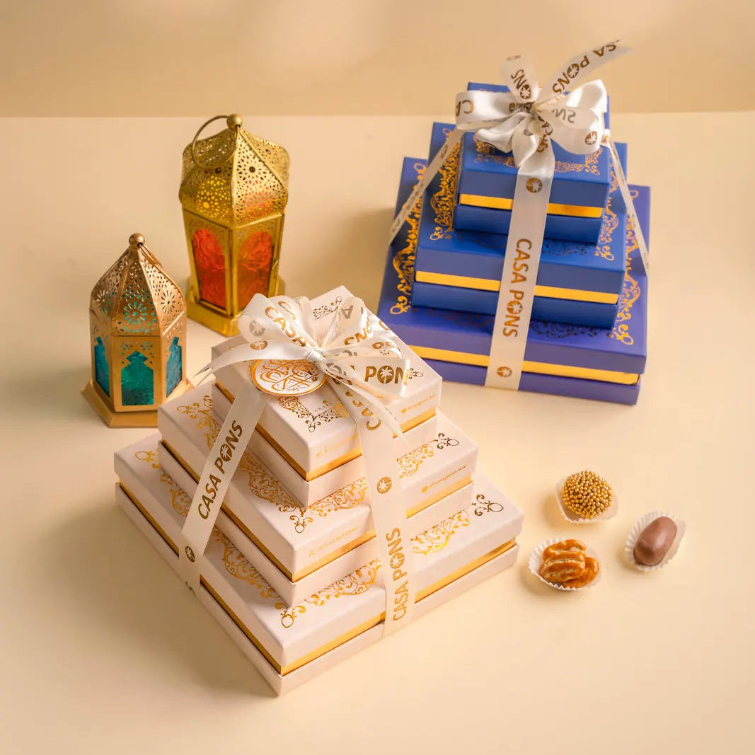 Decorative gift boxes with lanterns and small items on a beige background