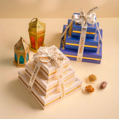 Decorative gift boxes with lanterns and small items on a beige background