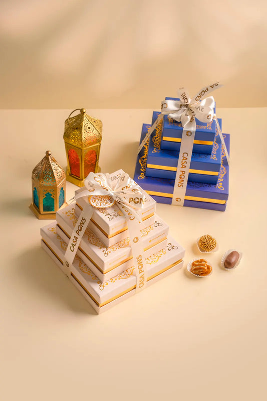 Decorative gift boxes with lanterns and small items on a beige background