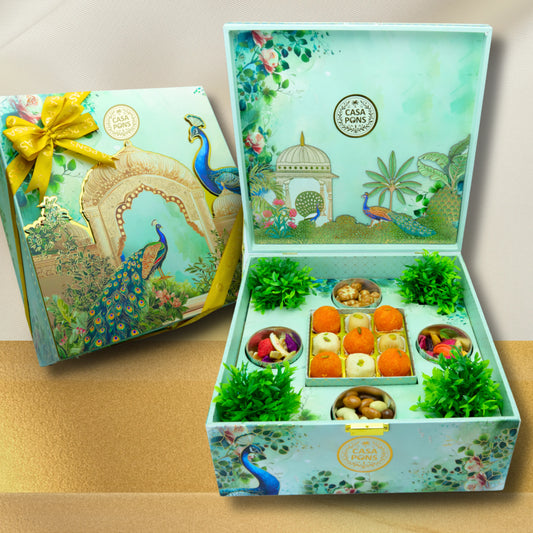 VIP Peacock Extra Large Box with Indian sweets, 4 bottles of pecan caramel, dehydrated vegetables, freeze-dried fruit, and assorted wafers in a handcrafted Indian gift box with diya decoration – luxury Diwali and Eid gift in the UAE.